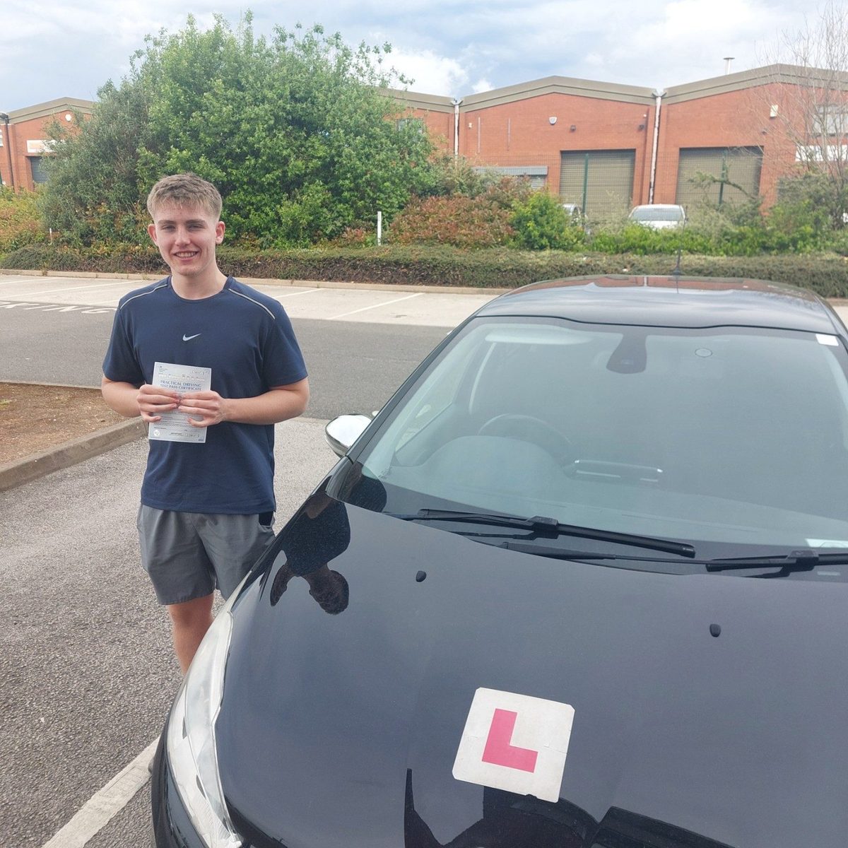 Successful Mals Driving School pupil holding a practical driving test pass certificate