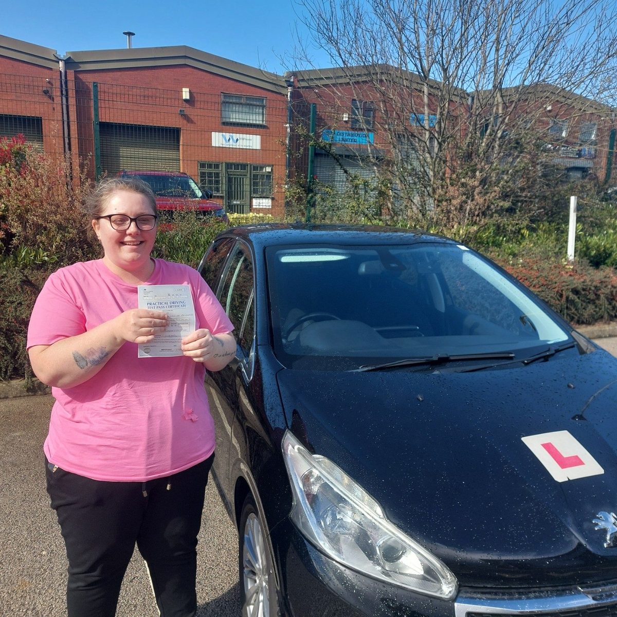 Successful Mals Driving School pupil holding a practical driving test pass certificate