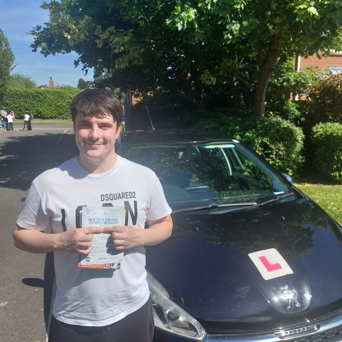 Successful Mals Driving School pupil holding a practical driving test pass certificate