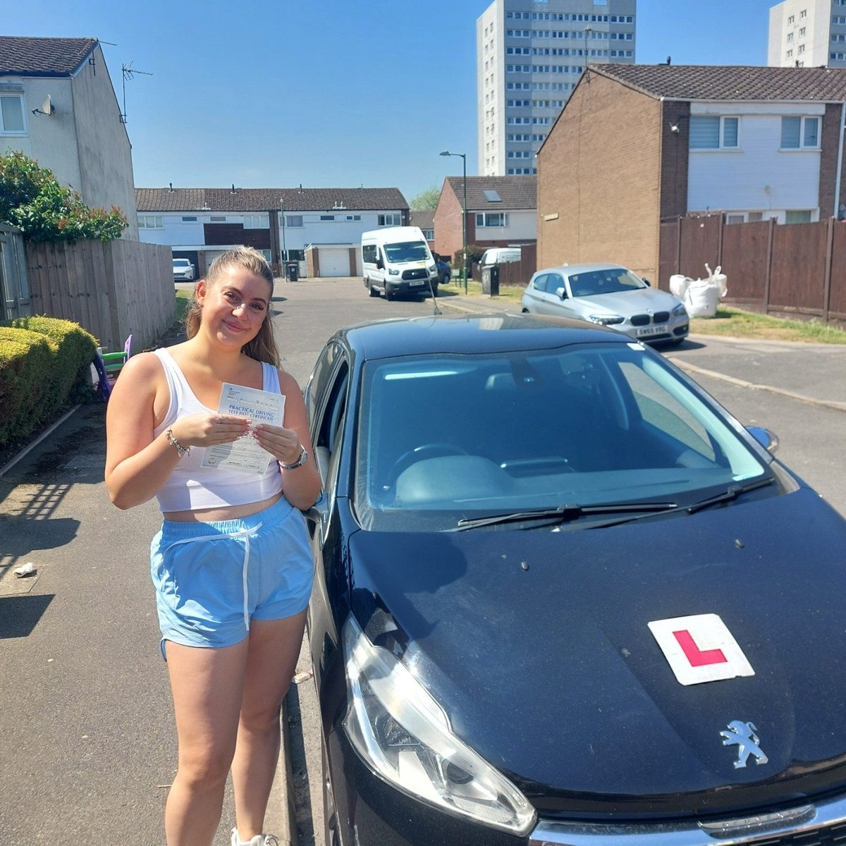 Successful Mals Driving School pupil holding a practical driving test pass certificate