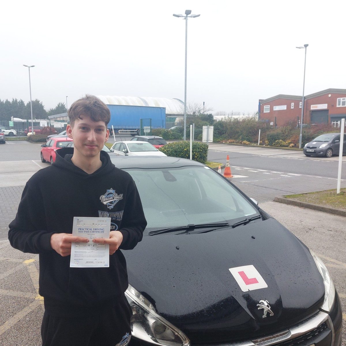 Successful Mals Driving School pupil holding a practical driving test pass certificate