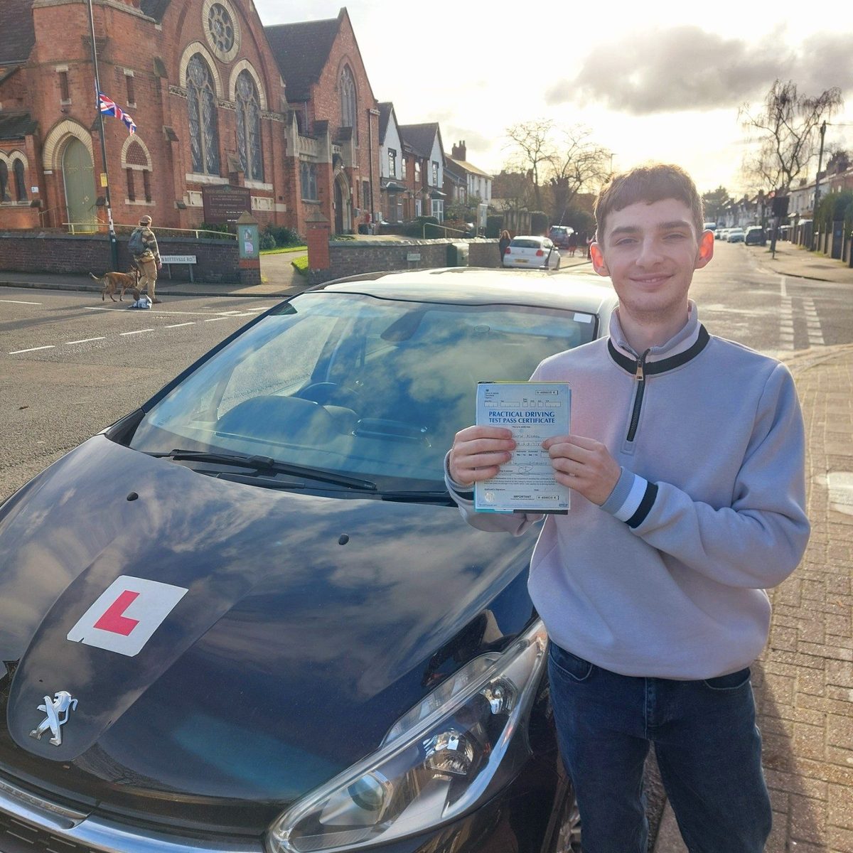 Successful Mals Driving School pupil holding a practical driving test pass certificate