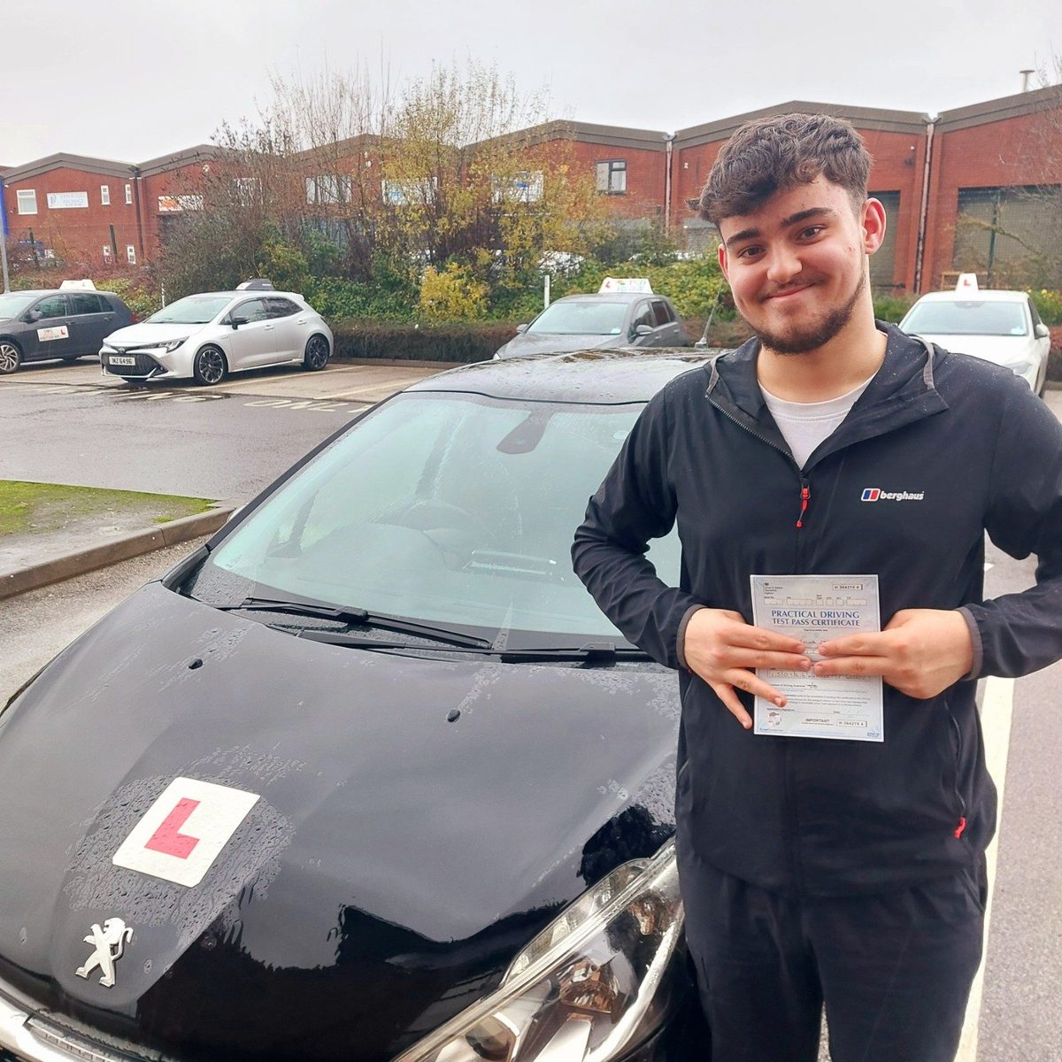 Successful Mals Driving School pupil holding a practical driving test pass certificate
