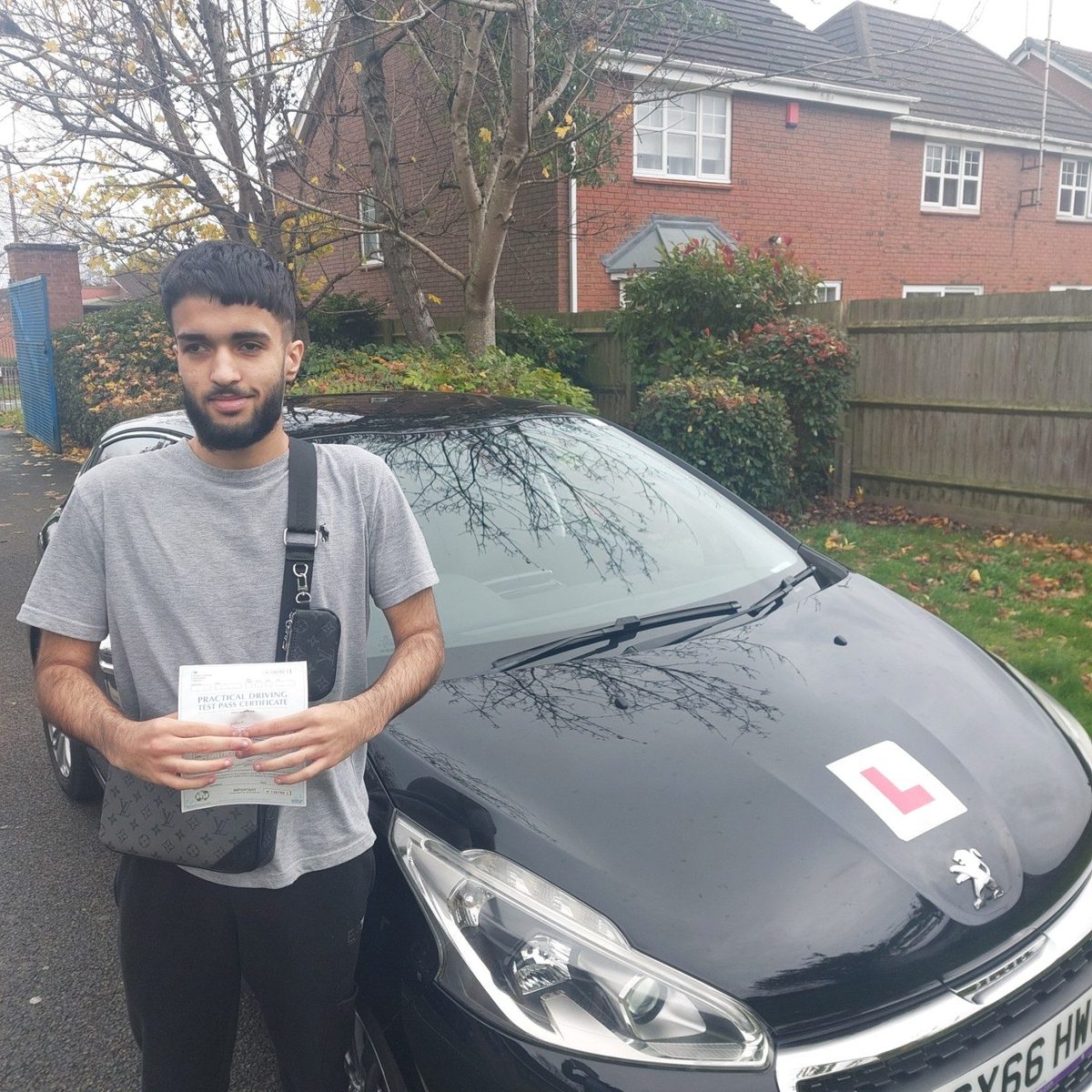 Successful Mals Driving School pupil holding a practical driving test pass certificate