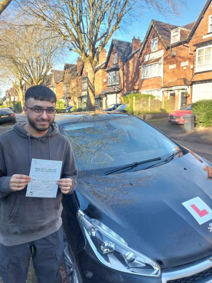 Successful Mals Driving School pupil holding a practical driving test pass certificate