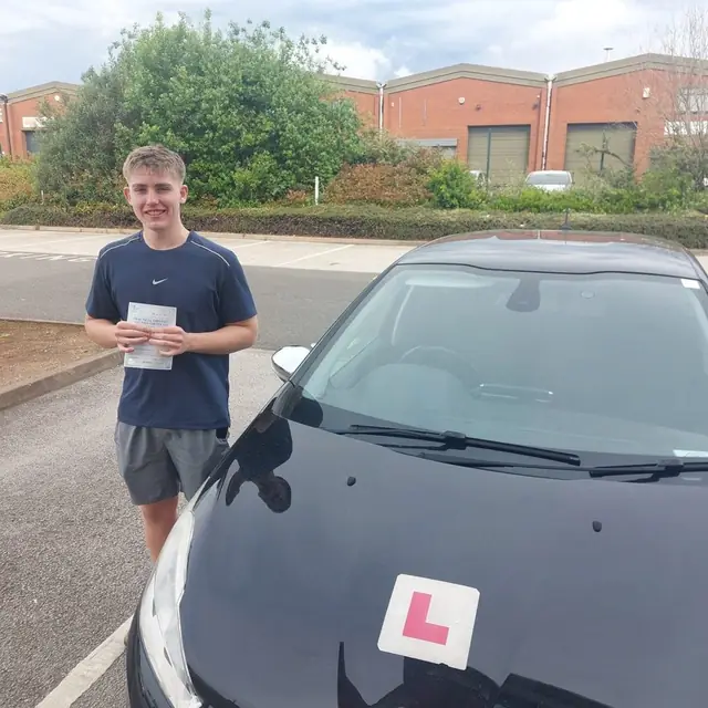 Successful Mals Driving School pupil holding a practical driving test pass certificate