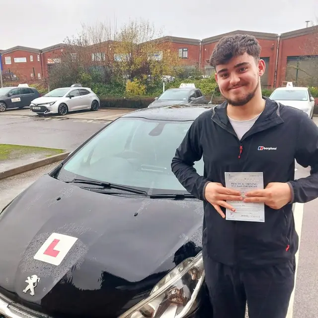 Successful Mals Driving School pupil holding a practical driving test pass certificate