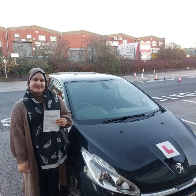 Successful Mals Driving School pupil holding a practical driving test pass certificate