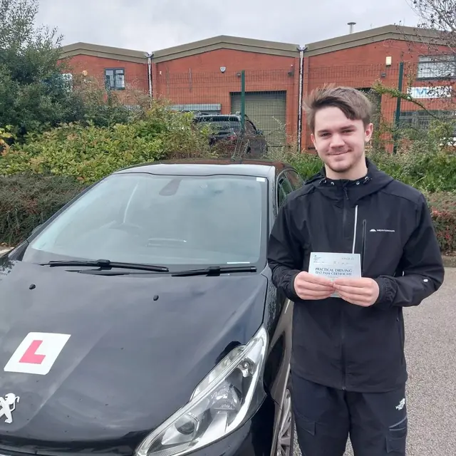 Successful Mals Driving School pupil holding a practical driving test pass certificate